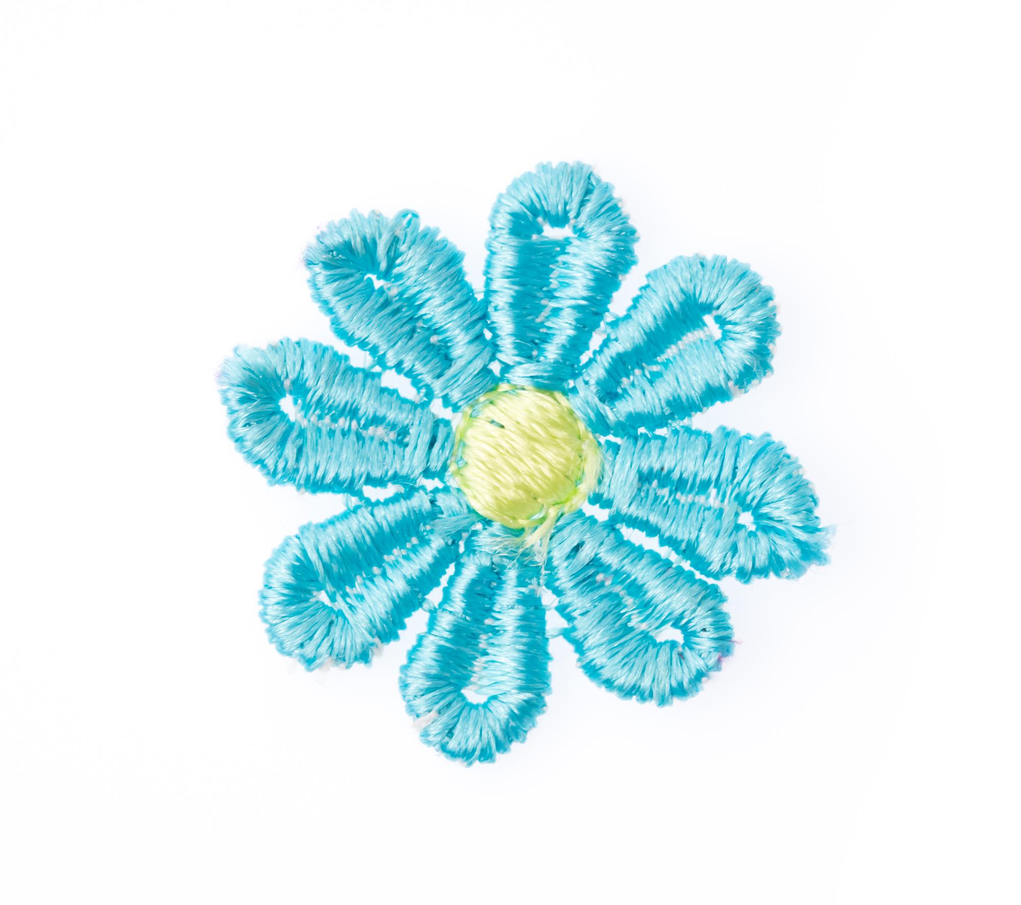 Small embroidered floral patch on linen
