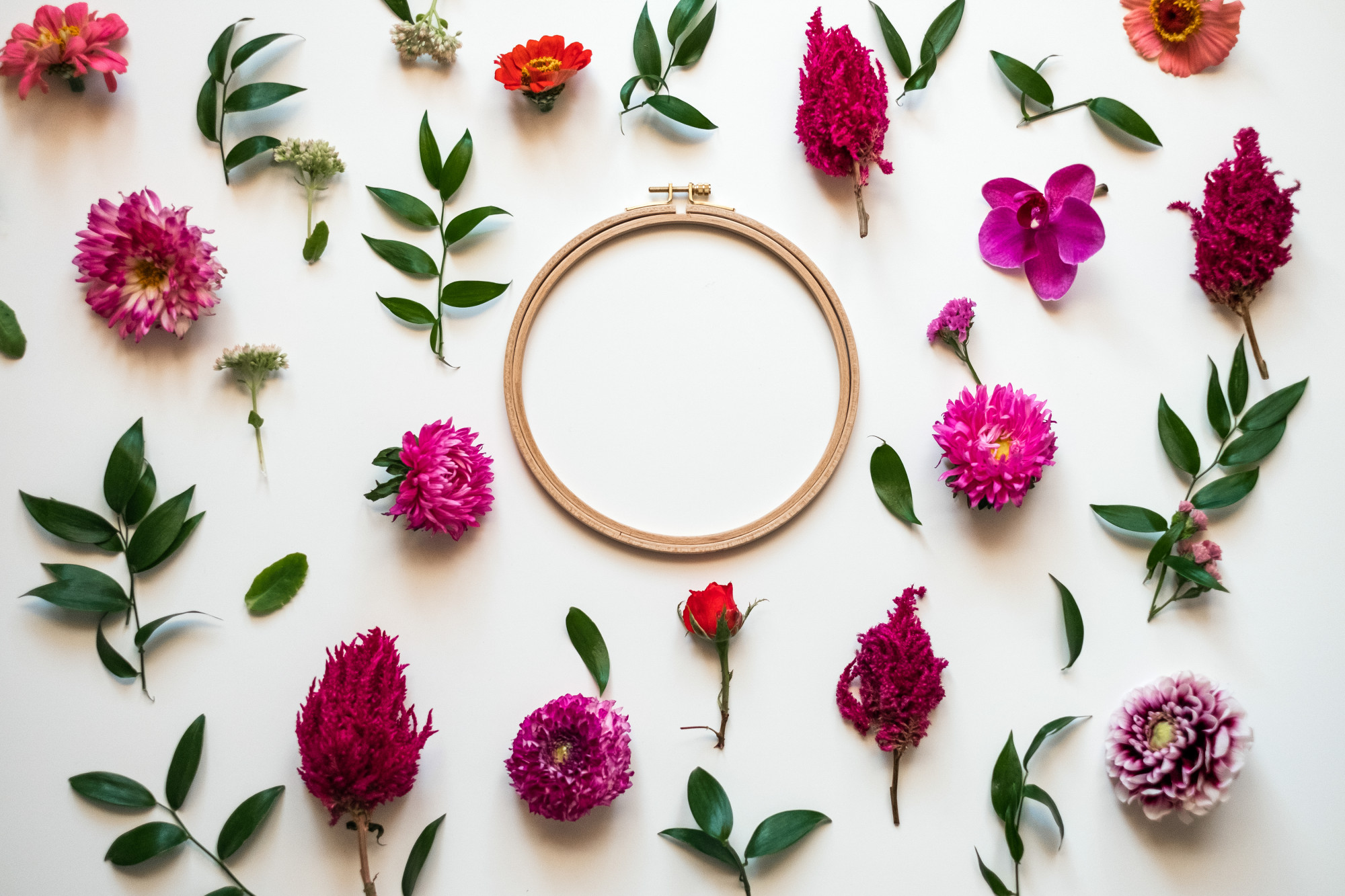 Detail of hand embroidery hoop with floral stitches